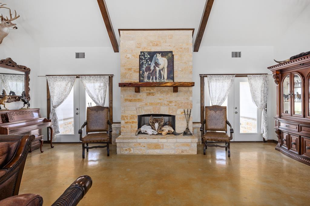 5025 Highway 16 Bandera, TX 78003 - Photo 11 of 49 a living room with furniture and a fireplace