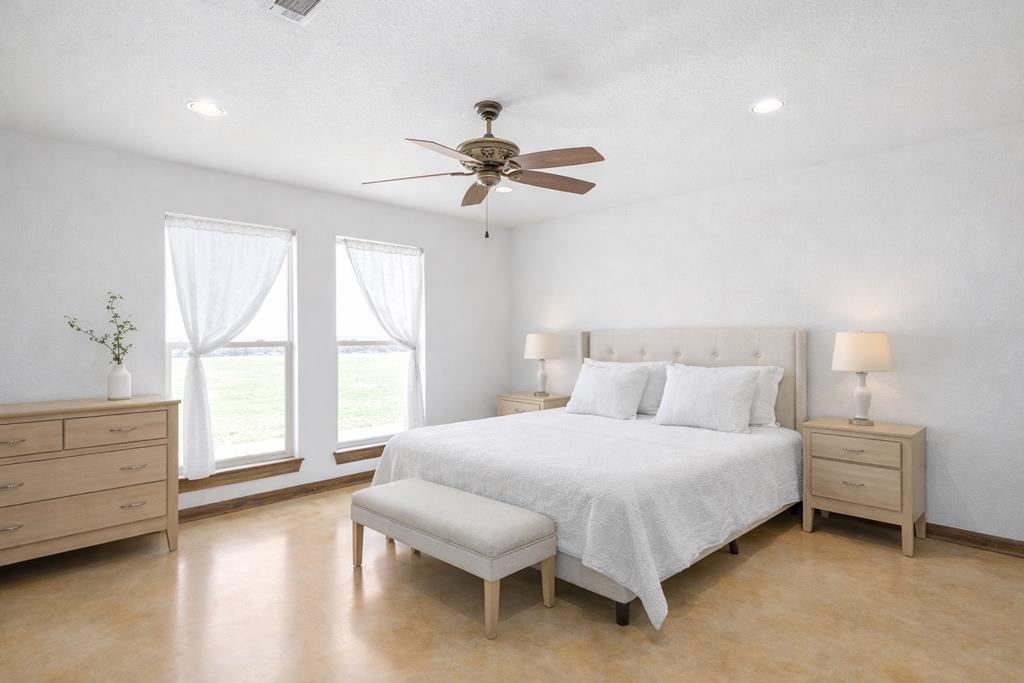 5025 Highway 16 Bandera, TX 78003 - Photo 18 of 49 a bedroom with a bed chandelier and a window