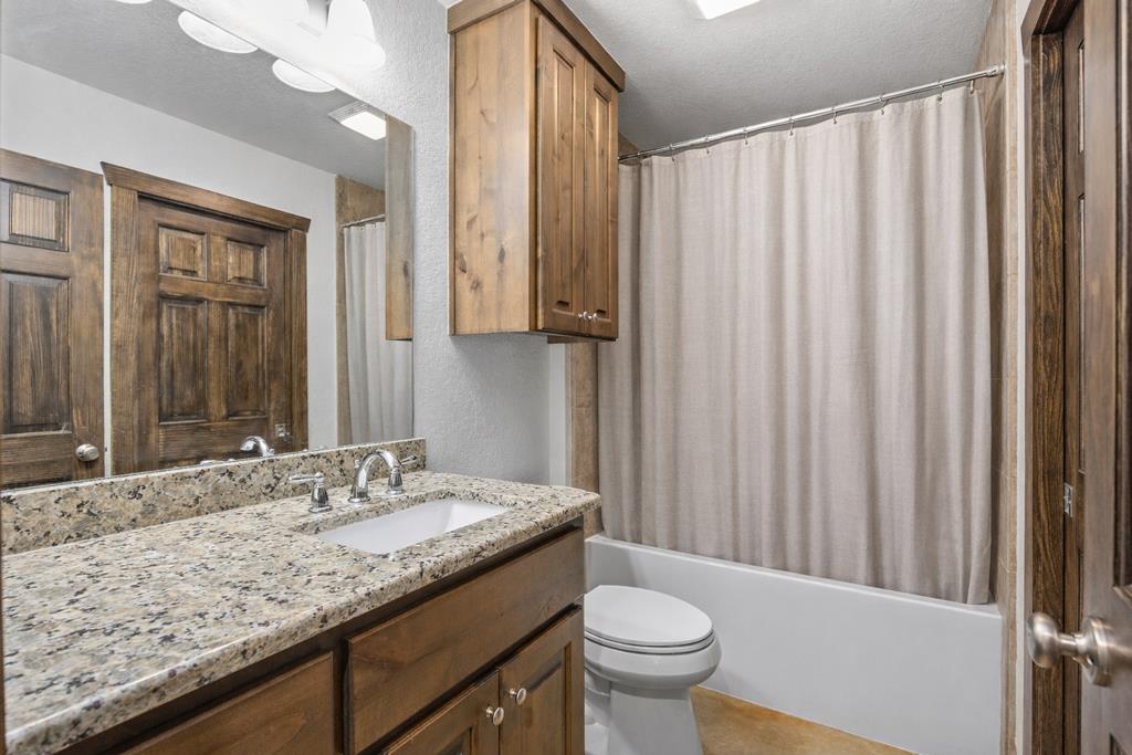 5025 Highway 16 Bandera, TX 78003 - Photo 19 of 49 a bathroom with a granite countertop sink and a mirror