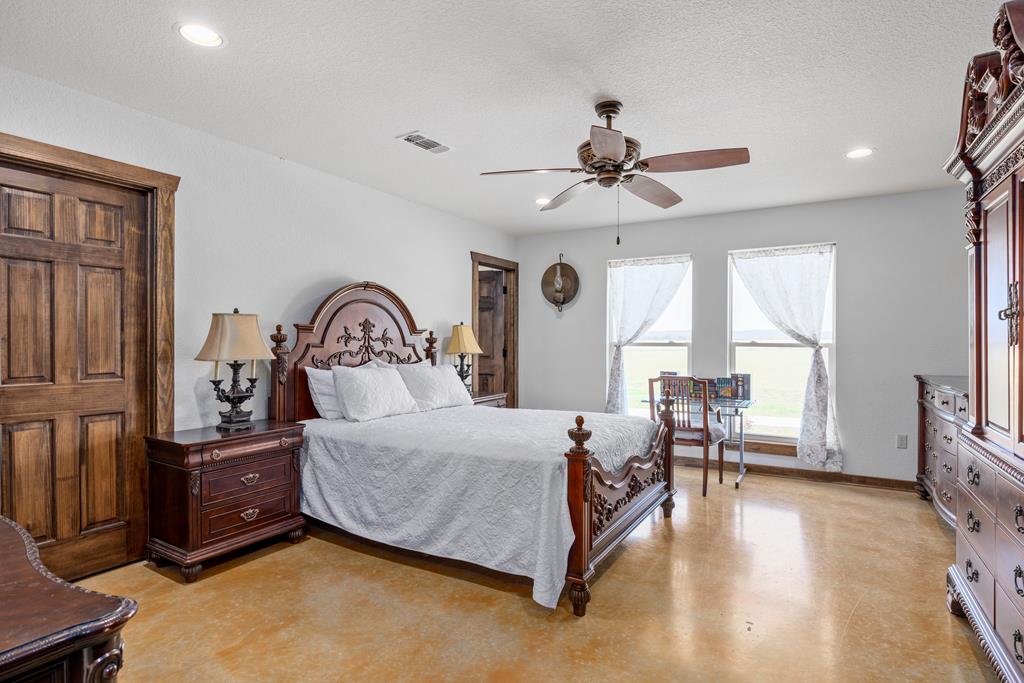 5025 Highway 16 Bandera, TX 78003 - Photo 20 of 49 a bedroom with a bed a large window and flat screen tv
