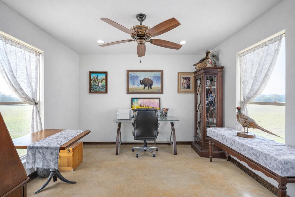5025 Highway 16 Bandera, TX 78003 - Photo 22 of 49 a view of a workspace with furniture and a window