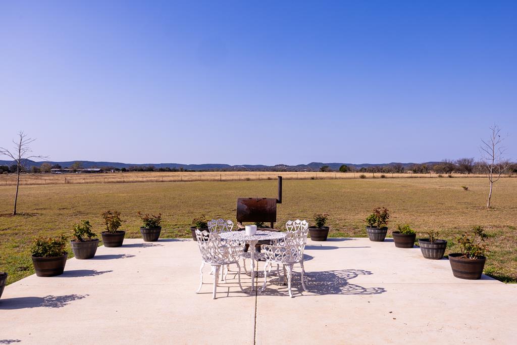 5025 Highway 16 Bandera, TX 78003 - Photo 27 of 49 a view of a ocean with a table and chairs under an umbrella
