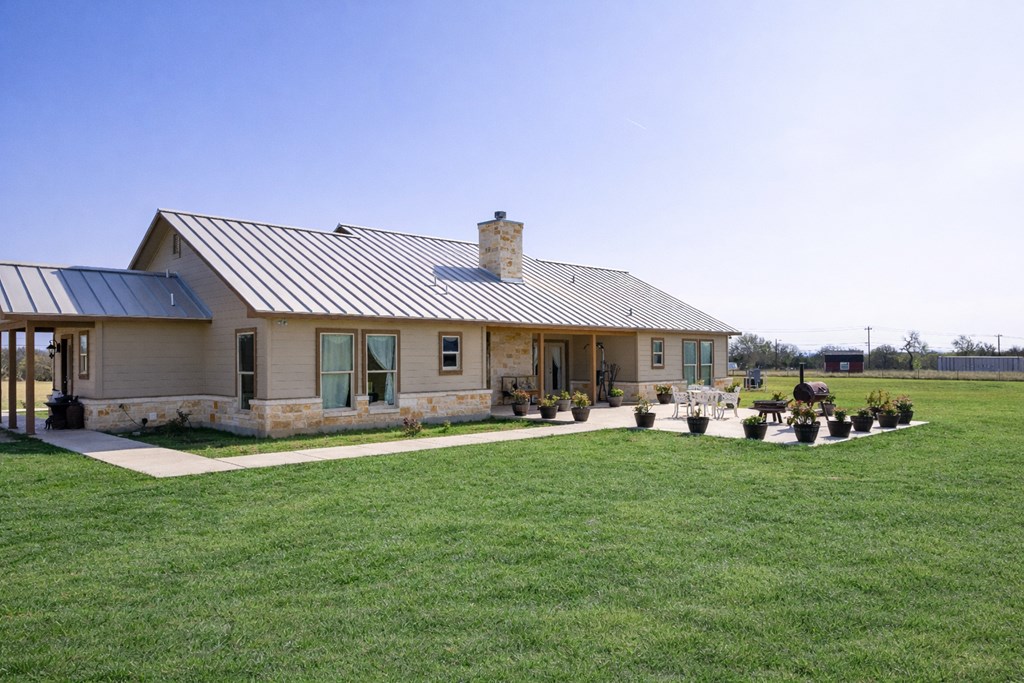 5025 Highway 16 Bandera, TX 78003 - Photo 3 of 49 a front view of a house with a garden and trees