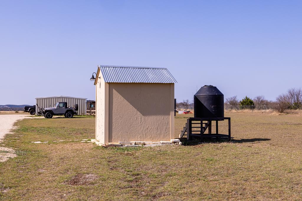 5025 Highway 16 Bandera, TX 78003 - Photo 34 of 49 a bedroom with furniture and natural light