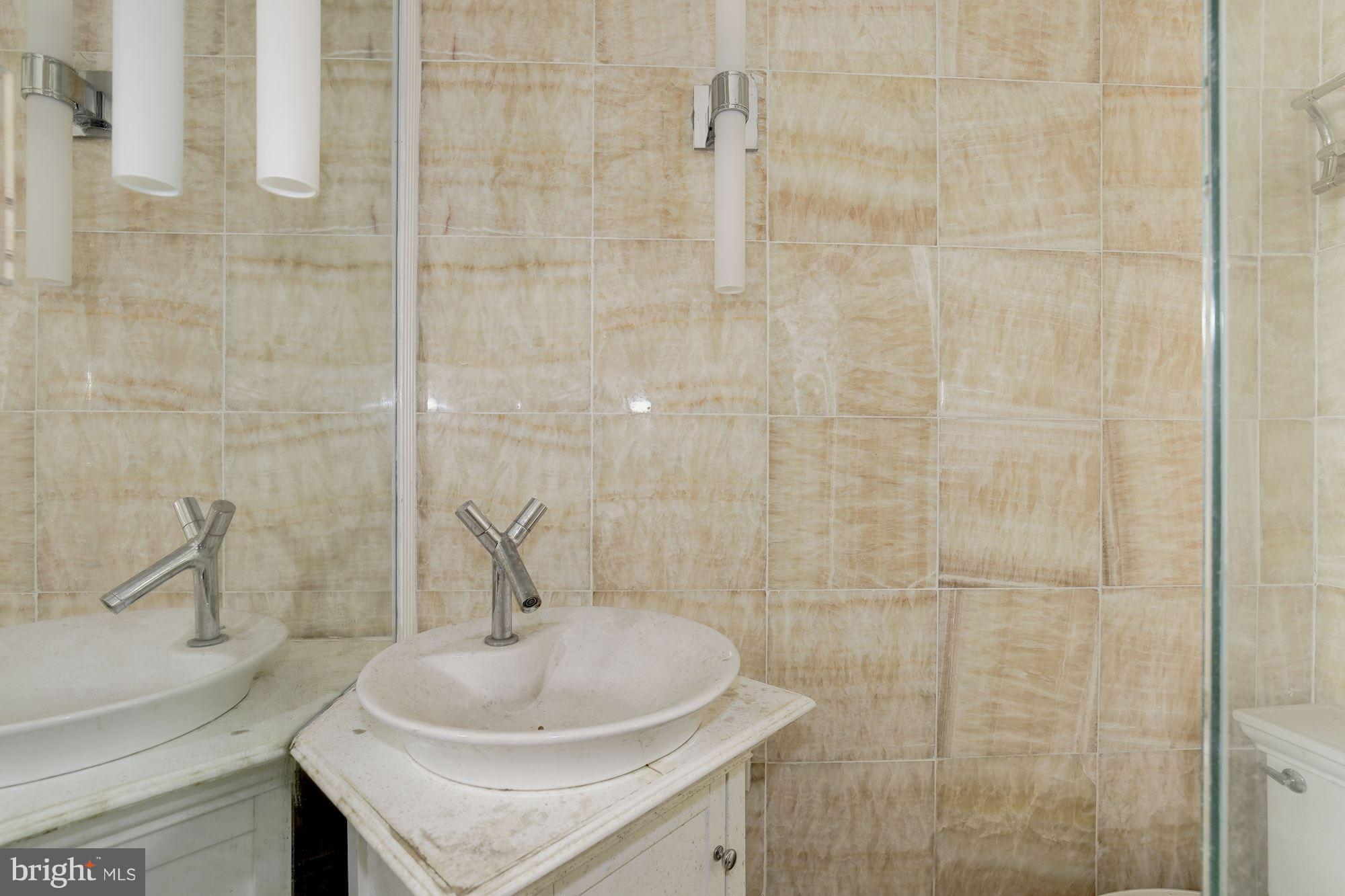 87 V Street Northwest Washington, DC 20001 - Photo 26 of 30 a bathroom with a sink a toilet and shower