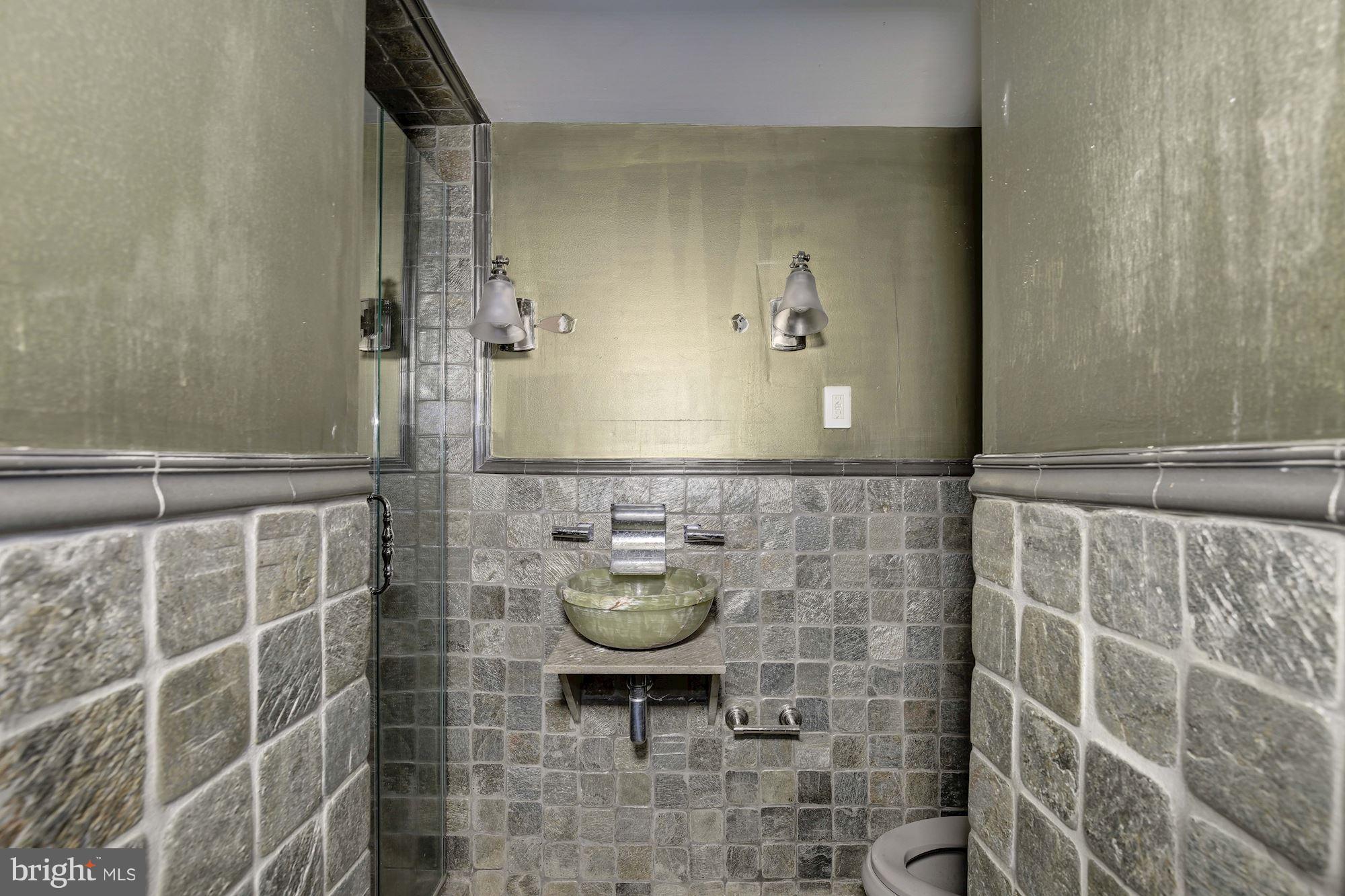 87 V Street Northwest Washington, DC 20001 - Photo 29 of 30 a bathroom with a sink and a mirror