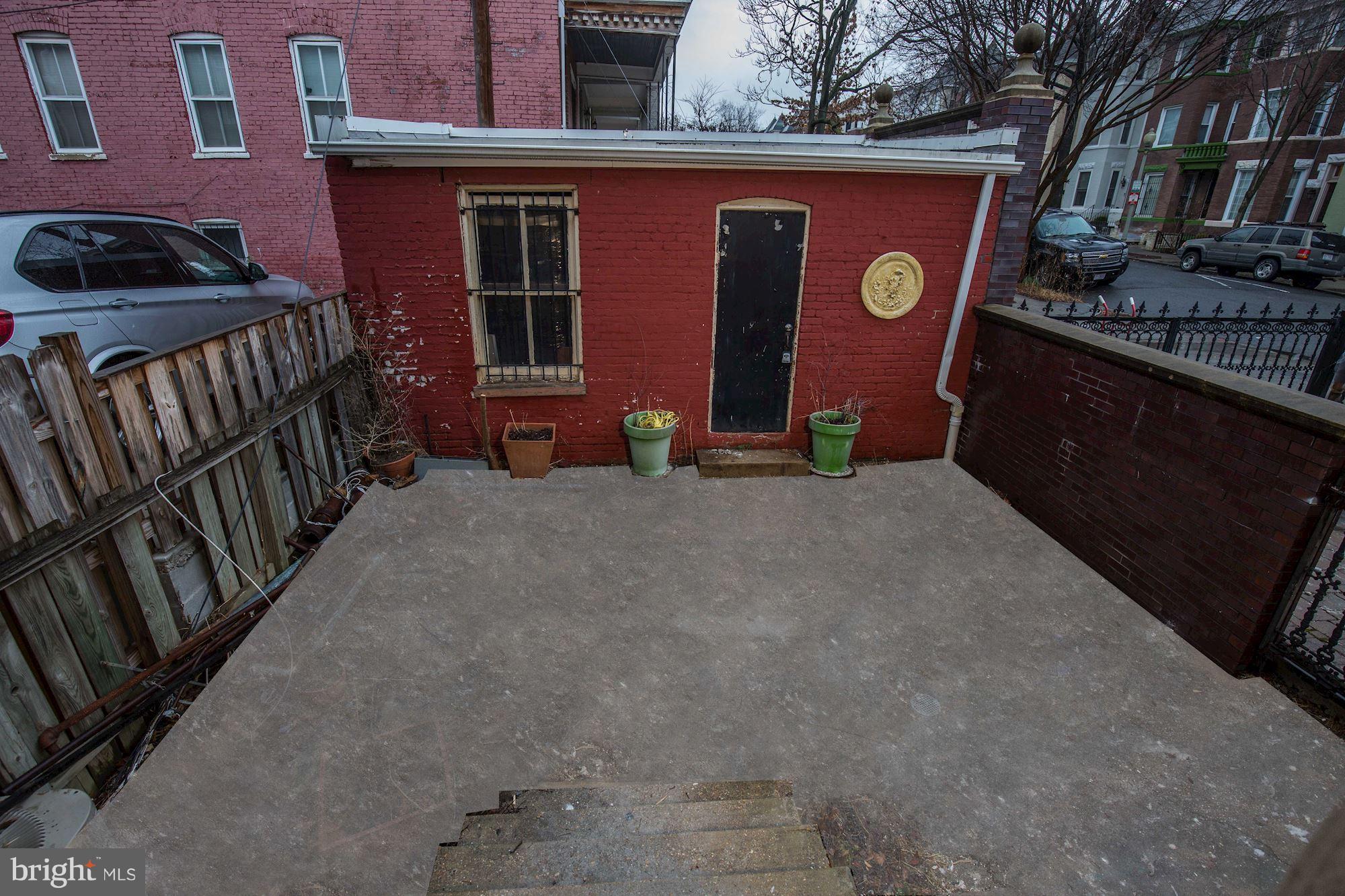 87 V Street Northwest Washington, DC 20001 - Photo 30 of 30 a view of a house with backyard and furniture