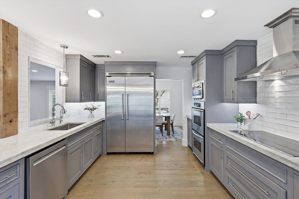 4310 Forest Bend Road Dallas, TX 75244 - Photo 12 of 40 Galley kitchen featuring light wood-finish flooring, recessed lighting, and a neutral color palette