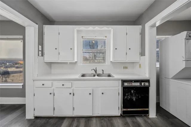 a kitchen with white cabinets and a sink