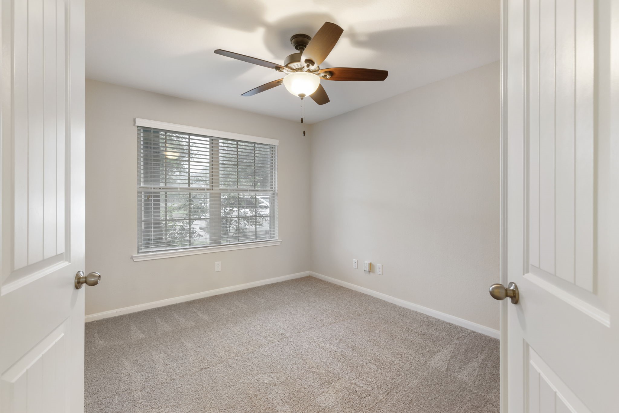 7130 Edwanna Lane Spring, TX 77389 - Photo 6 of 36 Double privacy doors lead to the study with front yard views, ceiling fan and brand new carpet.