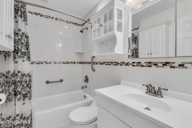 a bathroom with a sink a toilet and bathtub