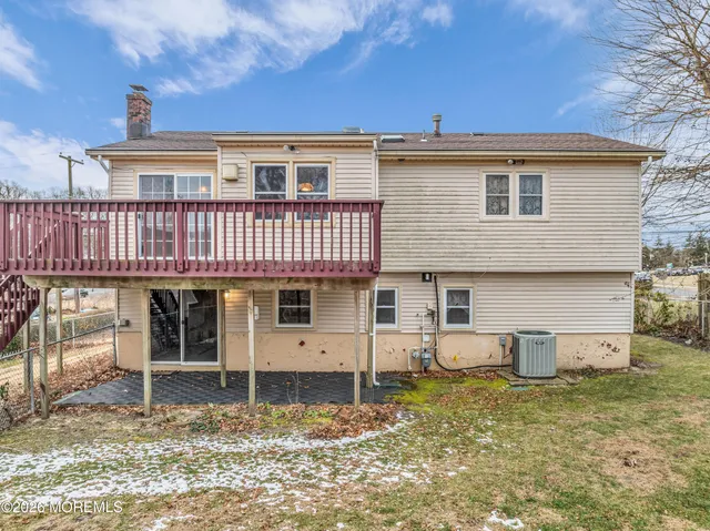 a view of a house with a wooden deck