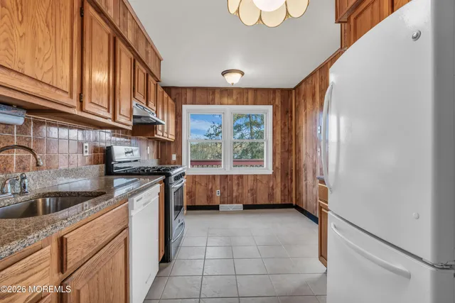 a kitchen that has a sink a stove and a window