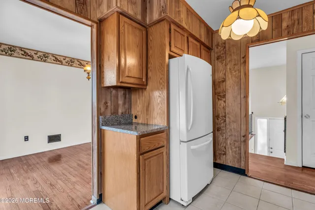 a kitchen with stainless steel appliances granite countertop a refrigerator and a stove