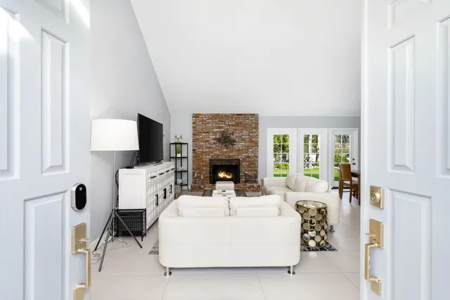 a living room with furniture a fireplace and a flat screen tv