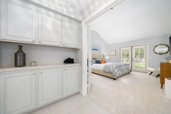a bedroom with furniture and a large window