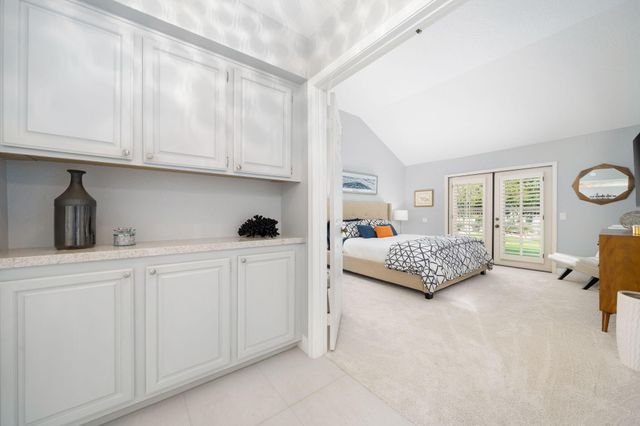 a bedroom with furniture and a large window