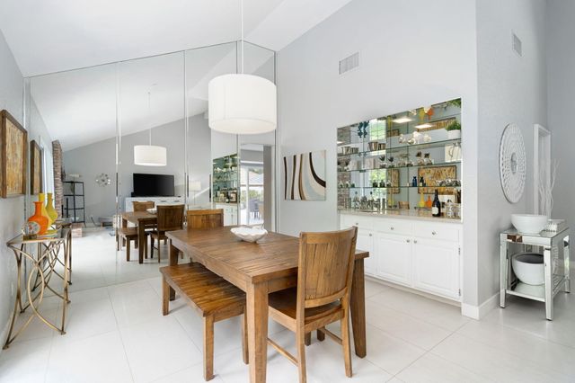 a view of a dining room with furniture and chandelier