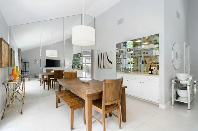 a view of a dining room with furniture and chandelier