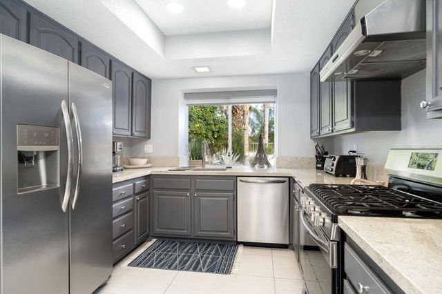 a kitchen with stainless steel appliances a sink stove and refrigerator