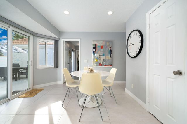 a dining room with furniture and a window