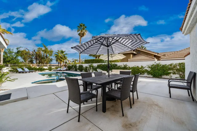 an outdoor space with furniture and umbrella