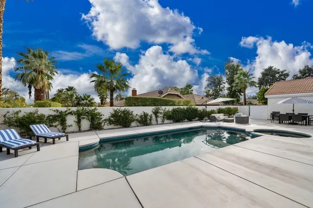 a view of a patio with couches and a table and chairs with potted plants