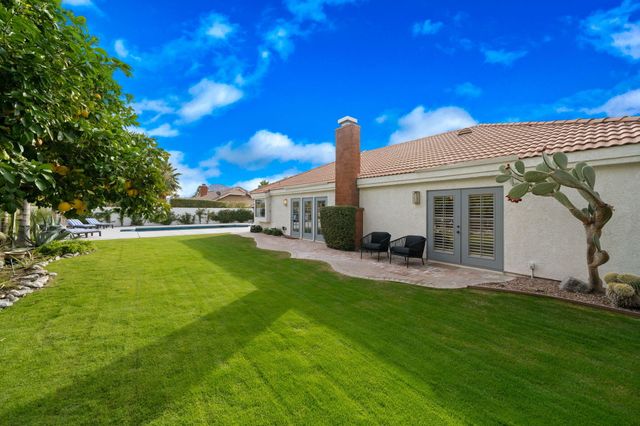 a view of a house with a backyard porch and sitting area