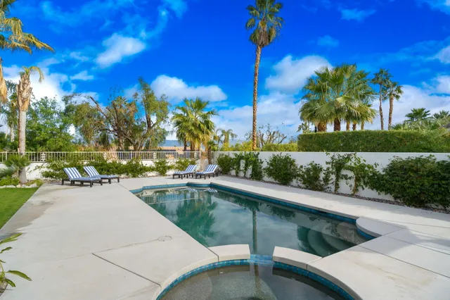 a view of a swimming pool with a patio
