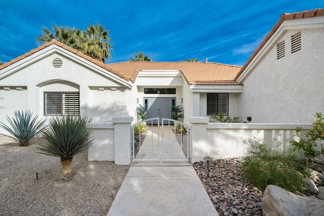 a view of a white house with swimming pool