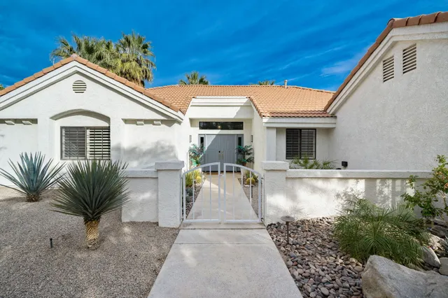 a view of a white house with swimming pool