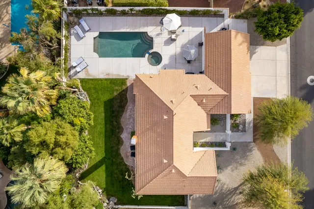 an aerial view of a house with a yard and trees