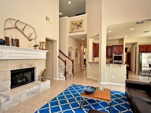 10908 Ariock Lane Austin, TX 78739 - Photo 1 of 1 a building with a rug and a fireplace