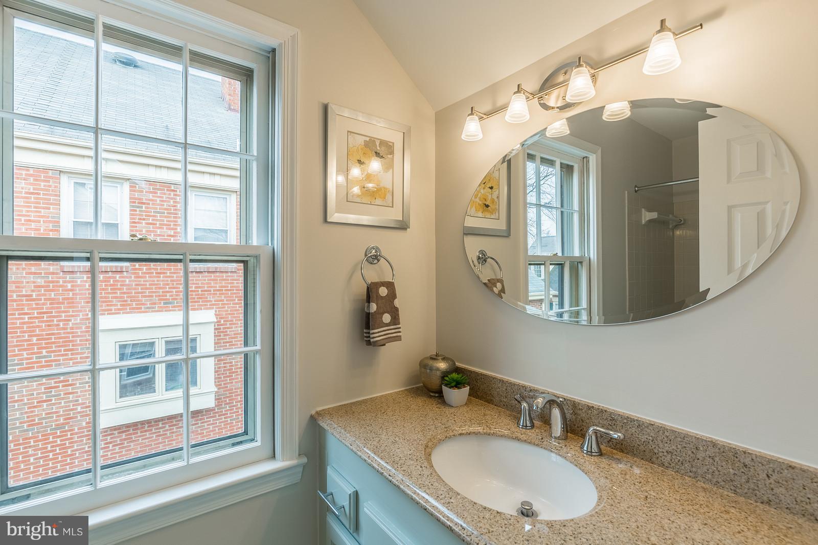 1237 Portner Road Alexandria, VA 22314 - Photo 16 of 17 a bathroom with a granite countertop sink and a large mirror