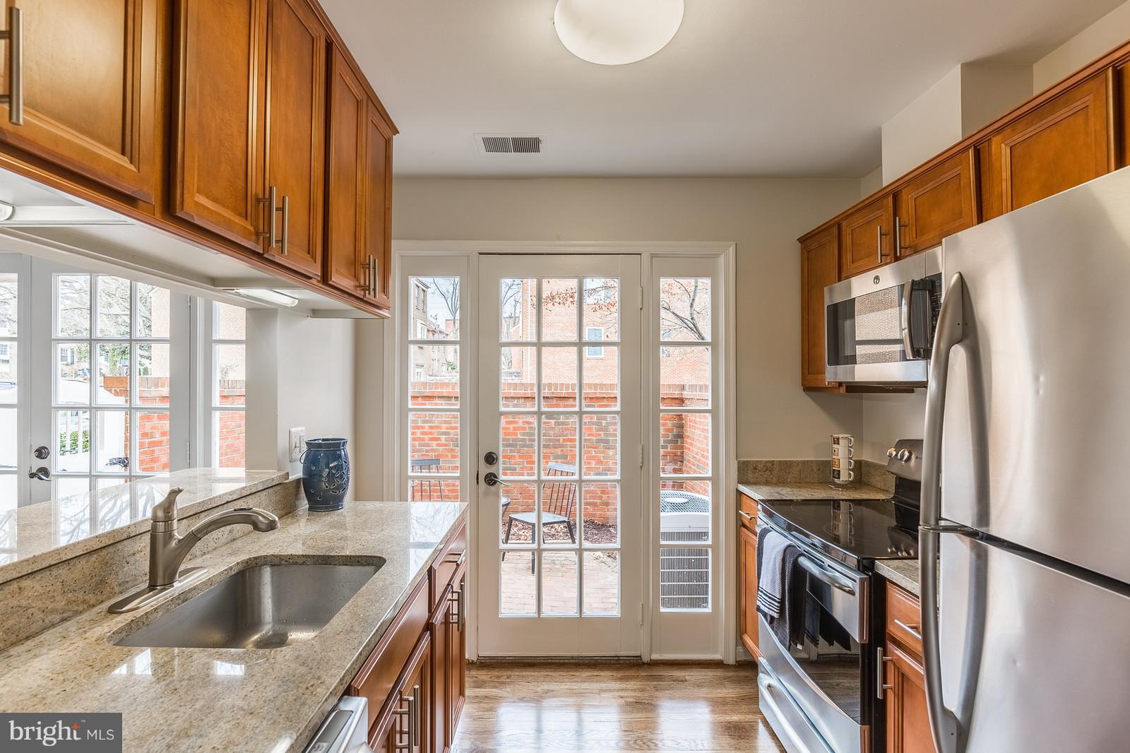 1237 Portner Road Alexandria, VA 22314 - Photo 5 of 17 a kitchen with granite countertop a refrigerator and a sink