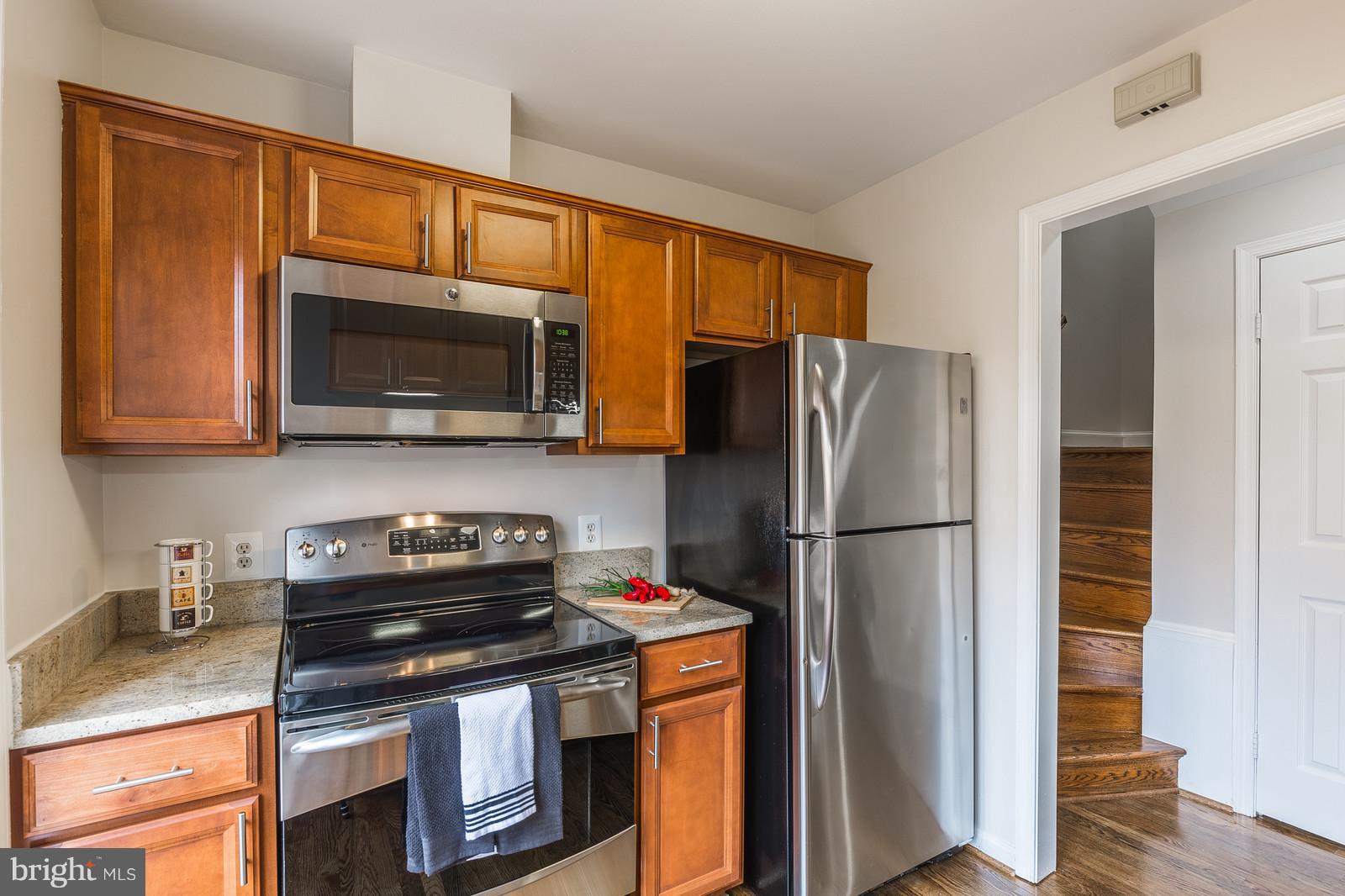1237 Portner Road Alexandria, VA 22314 - Photo 6 of 17 a kitchen with stainless steel appliances granite countertop a refrigerator stove top oven and sink