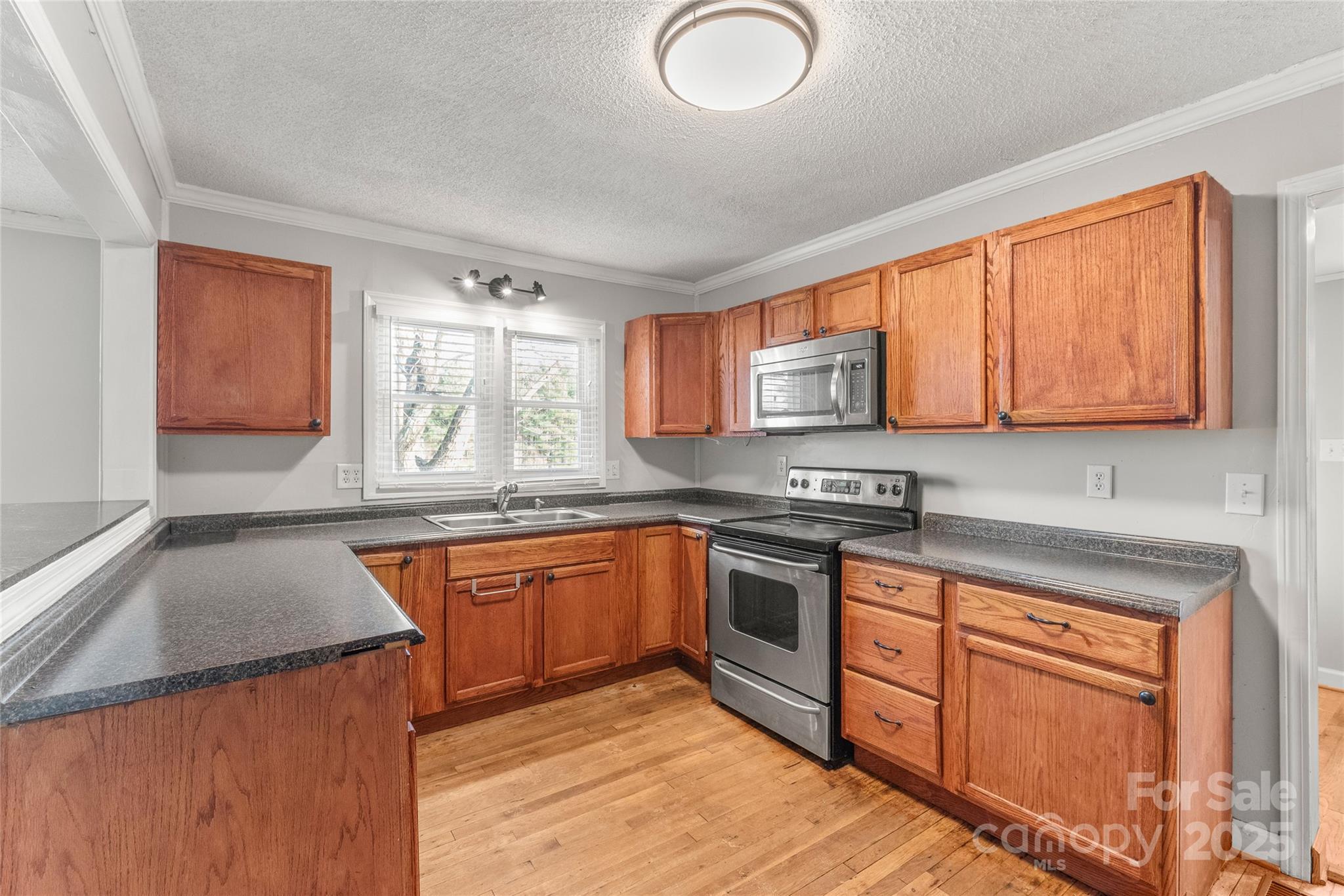 3933 Fallston-Waco Road Lawndale, NC 28090 - Photo 12 of 48 a kitchen with stainless steel appliances granite countertop a sink stove and microwave