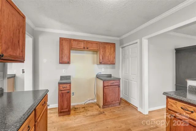 a kitchen with stainless steel appliances granite countertop a sink a stove a refrigerator a counter space and cabinets