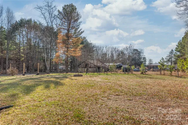a view of a yard with swimming pool