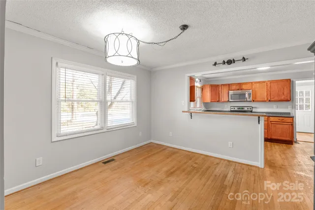 a view of a kitchen and an empty room