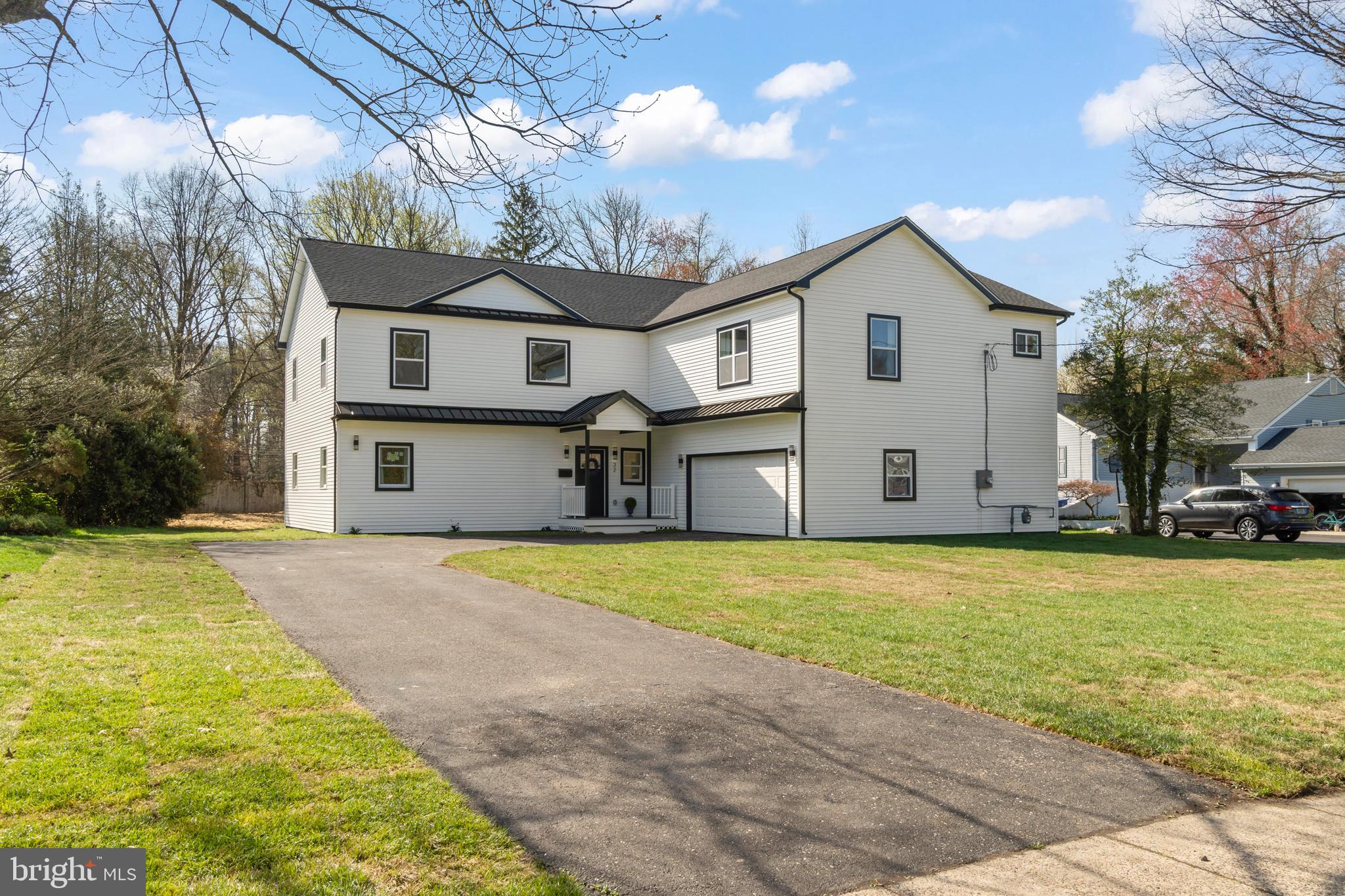 a view of an house with backyard and tree