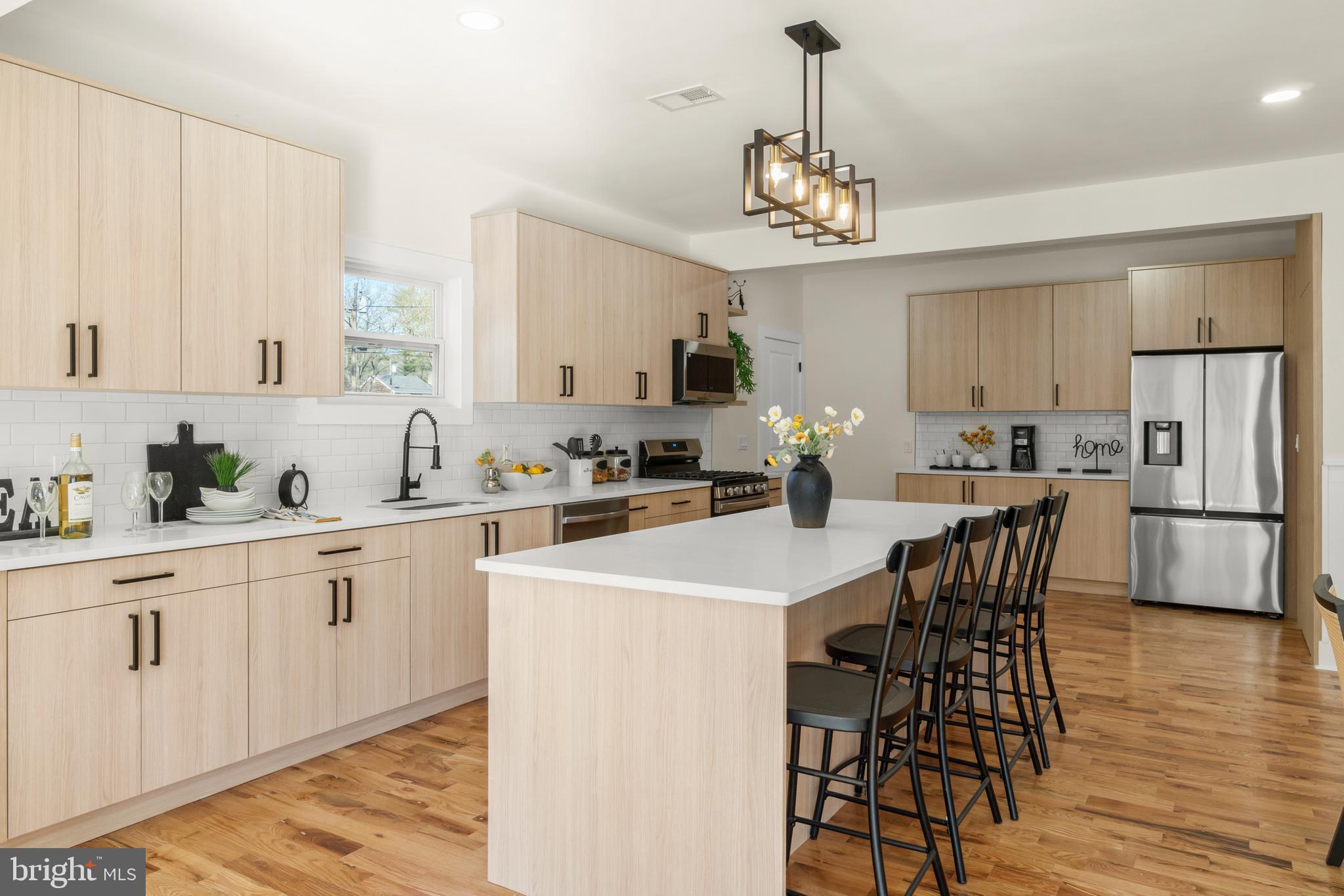 32 Wagon Bridge Run Moorestown, NJ 08057 - Photo 11 of 41 a kitchen with stainless steel appliances a dining table chairs stove refrigerator and cabinets
