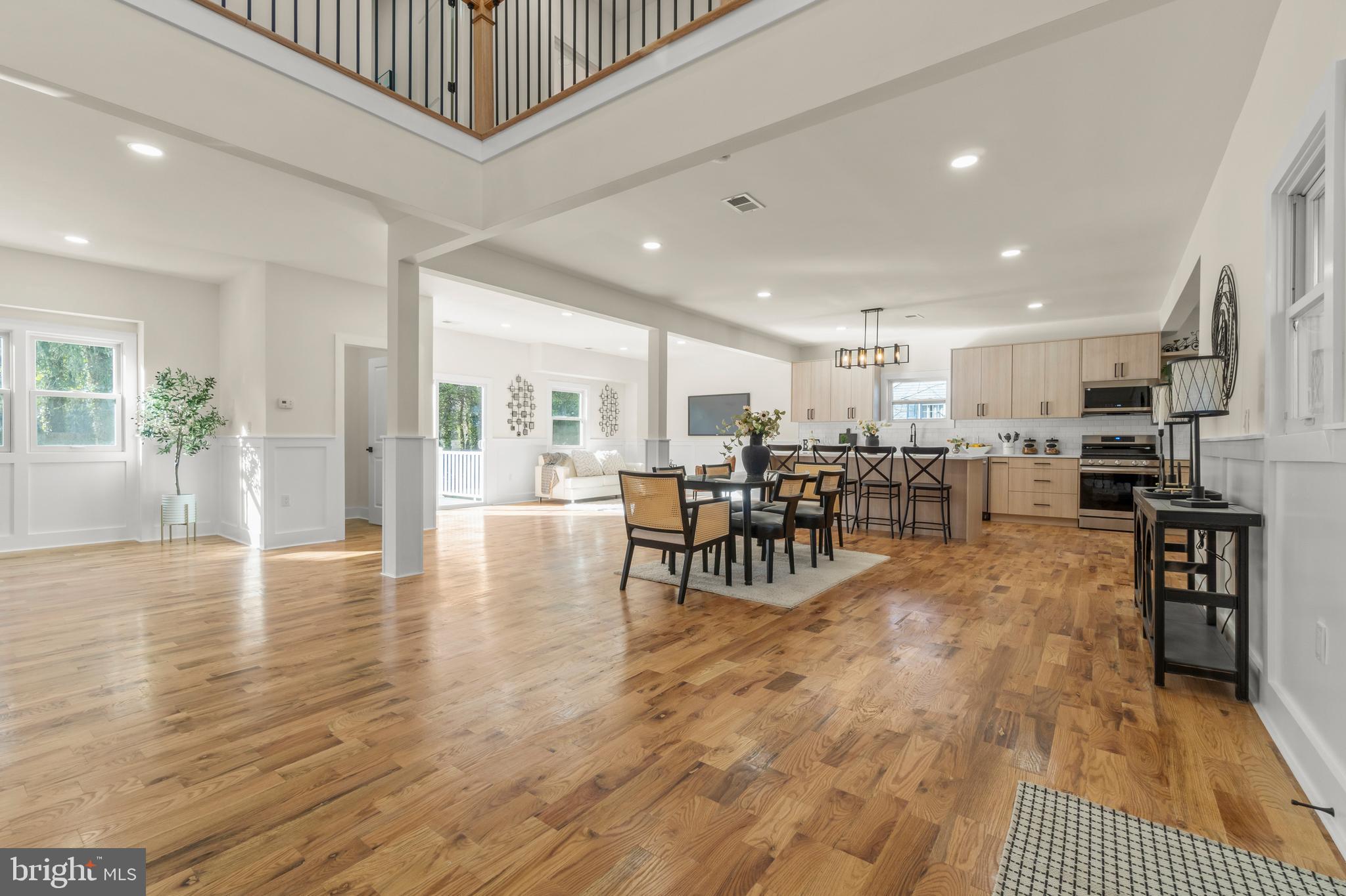 32 Wagon Bridge Run Moorestown, NJ 08057 - Photo 18 of 41 a view of a dining hall with a dining table chairs and couches with wooden floor