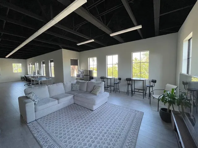a living room with furniture and wooden floors