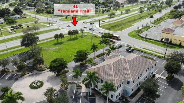 5900 Pan American Boulevard, Unit 205 North Port, FL 34287 - Photo 5 of 8 an aerial view of a swimming pool yard and outdoor seating