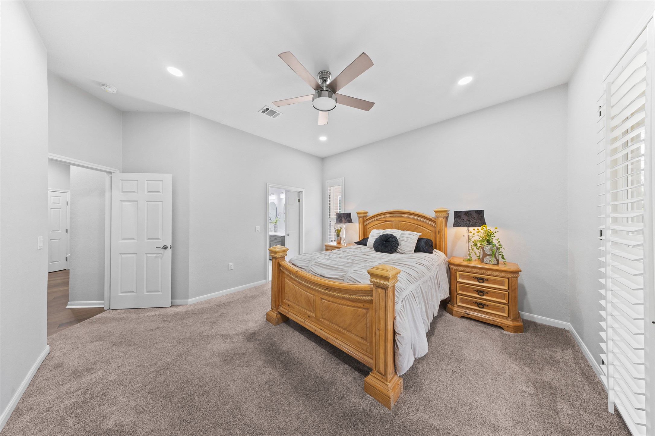 144 Stetson Trail Georgetown, TX 78633 - Photo 25 of 39 Carpeted primary bedroom featuring ensuite bathroom, and recessed lighting