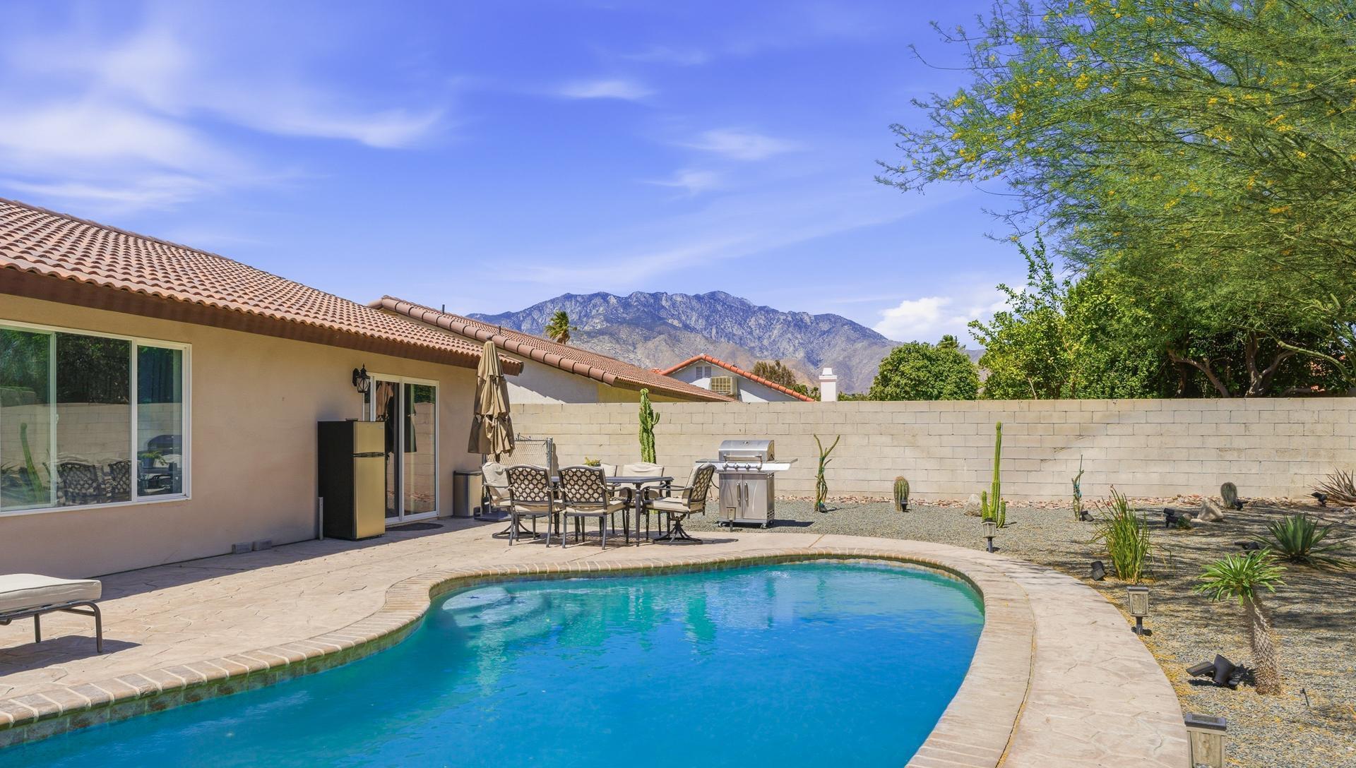 67220 Quijo Road Cathedral City, CA 92234 - Photo 8 of 26 a view of a swimming pool with a lounge chairs