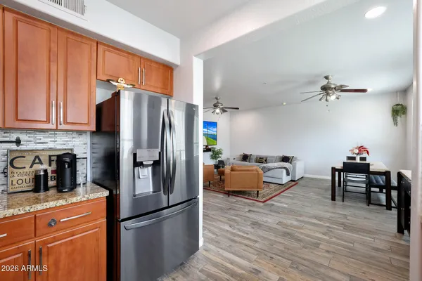 a kitchen with stainless steel appliances granite countertop a refrigerator stove microwave and cabinets
