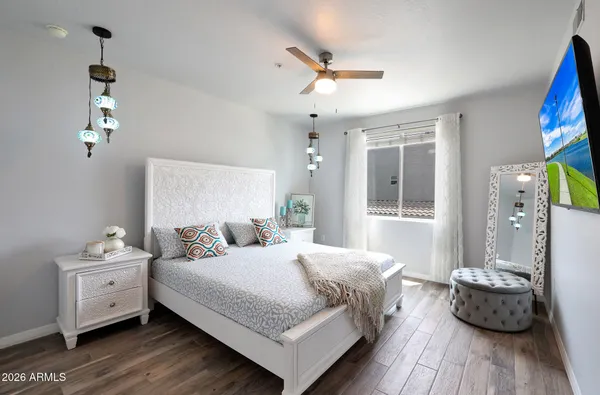 a bedroom with a bed and wooden floor