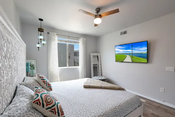 a bedroom with a bed and a chandelier